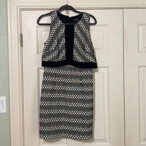 Sleeveless dress that looks like a top and bottom ensemble.